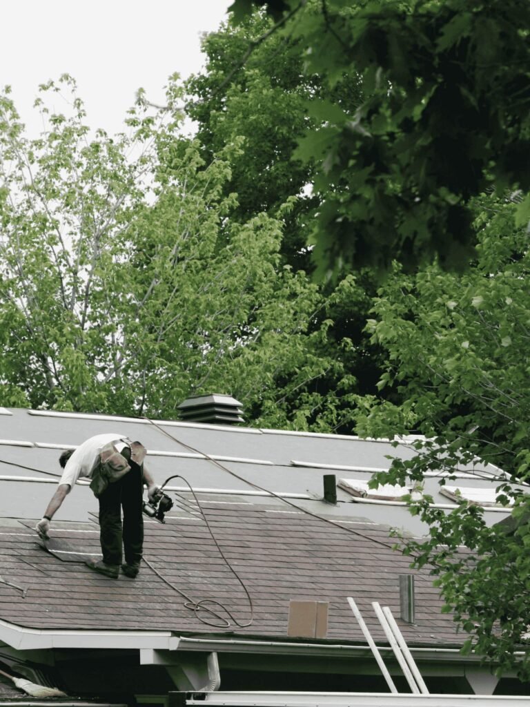 Roofing professional performing detailed asphalt shingle repair on a residential home by Dinosaur Roofing & Repair, delivering hands-on inspections, preventive maintenance, and dependable roof protection for homeowners in Middle Georgia