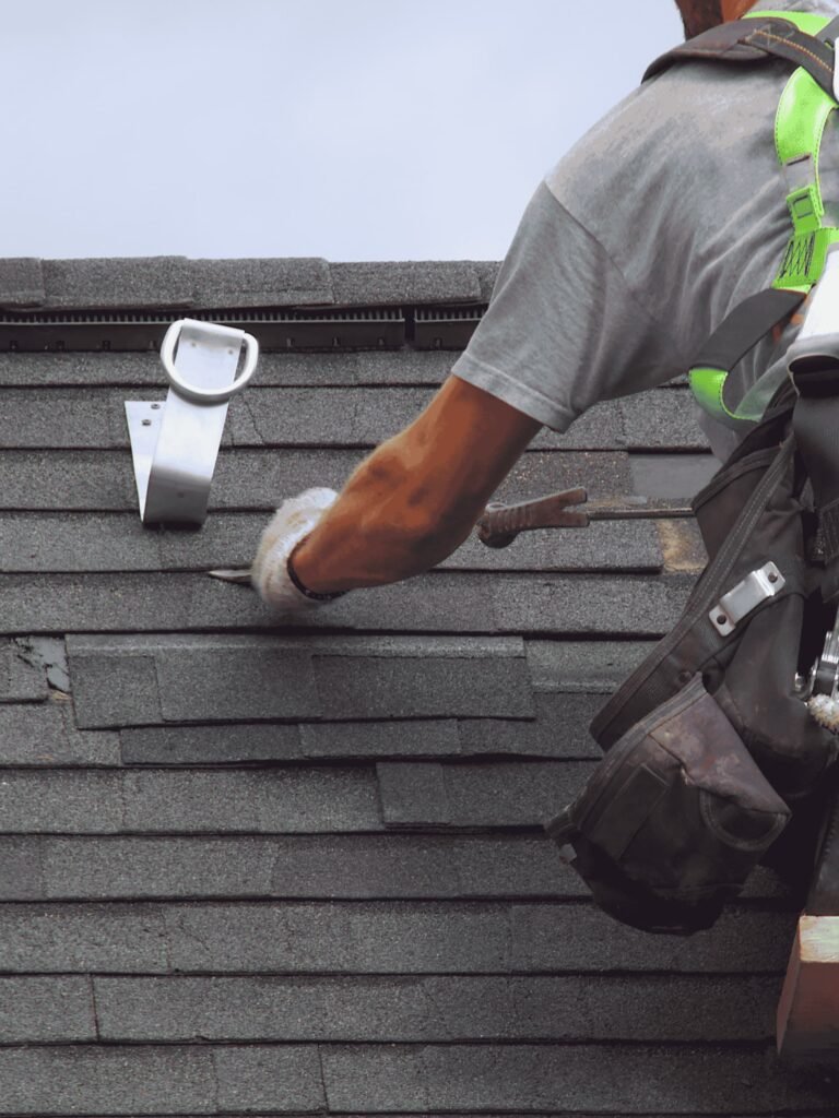 Close-up of roofing technician repairing asphalt shingles and flashing on a residential roof by Dinosaur Roofing & Repair, delivering precise leak prevention, durable materials, and reliable roof repair services for homeowners in Middle Georgia