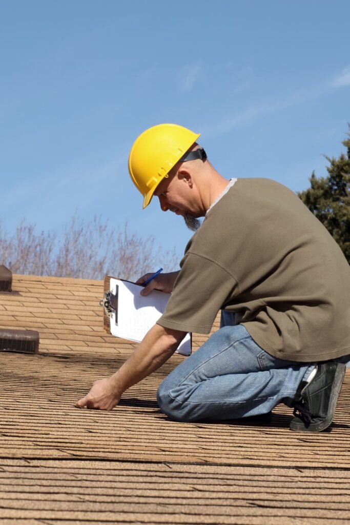 Roofing consultant conducting a hands-on roof inspection and documenting shingle condition during an on-site evaluation by Dinosaur Roofing & Repair, helping homeowners make informed roofing decisions in Middle Georgia